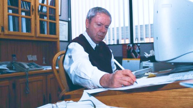 Bob Burnside writing at desk