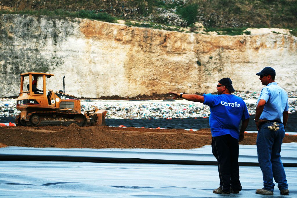 Men and Bulldozer in Solid Waste Cell