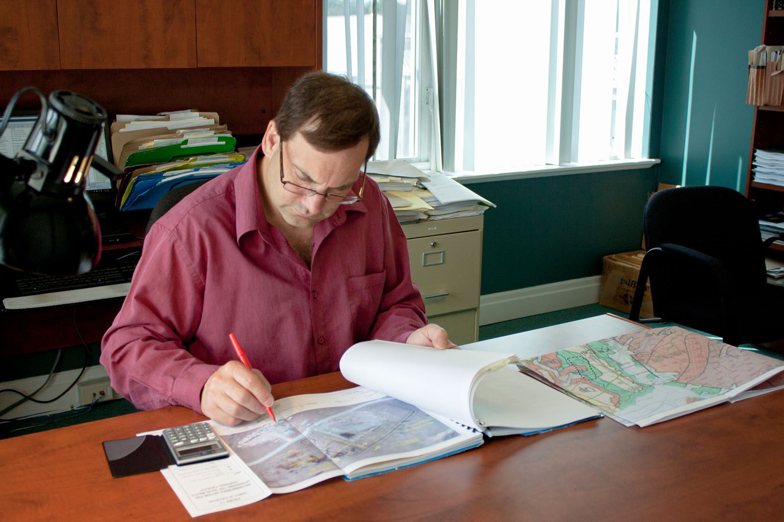 Person Sitting at Desk Doing Document Peer Review