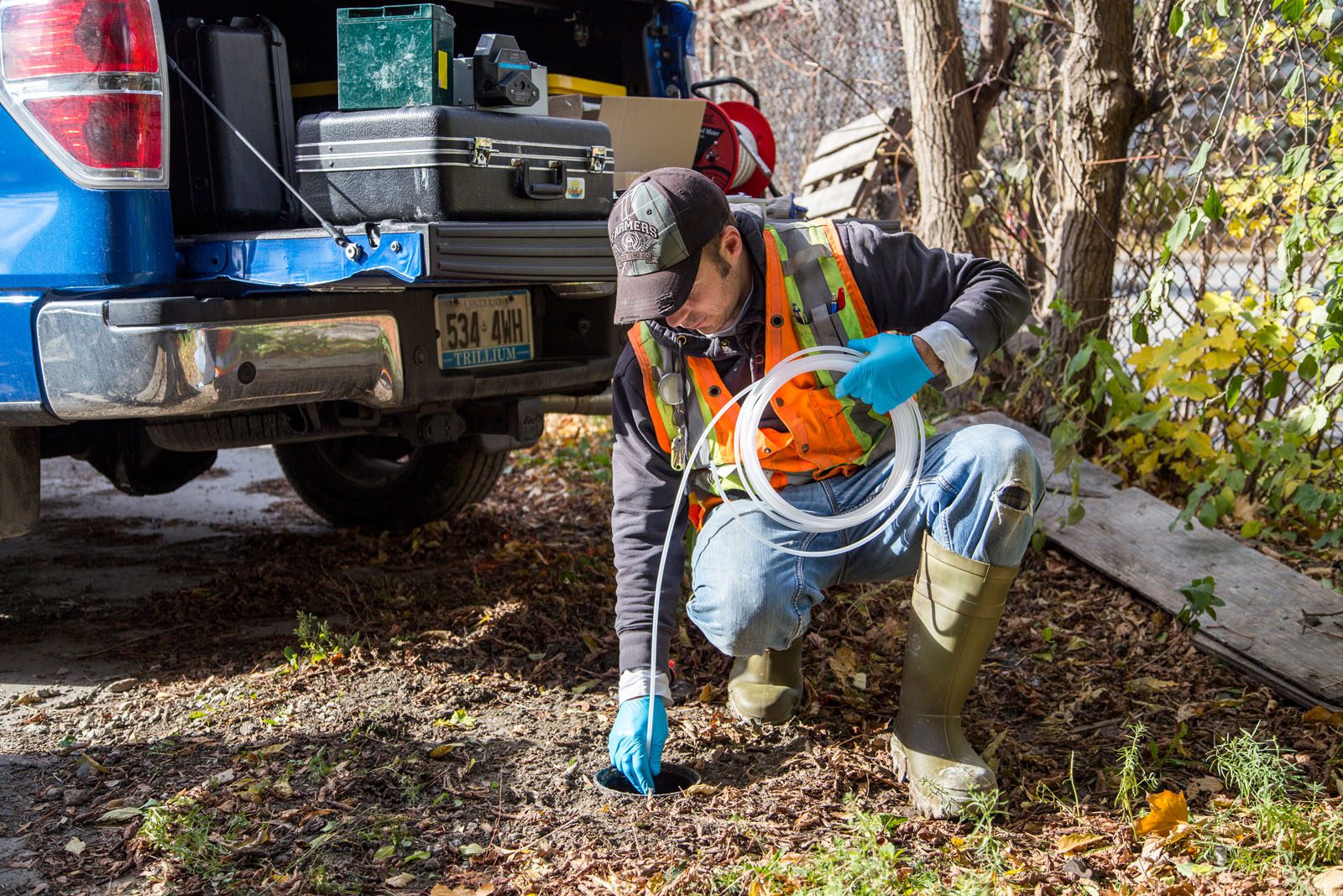 Tube being run into test well for water sampling