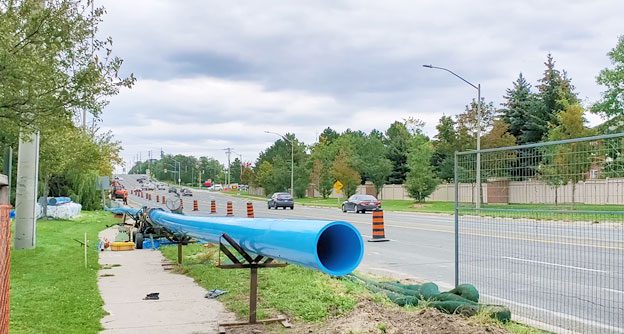 Watermain on side of roadway waiting for installation