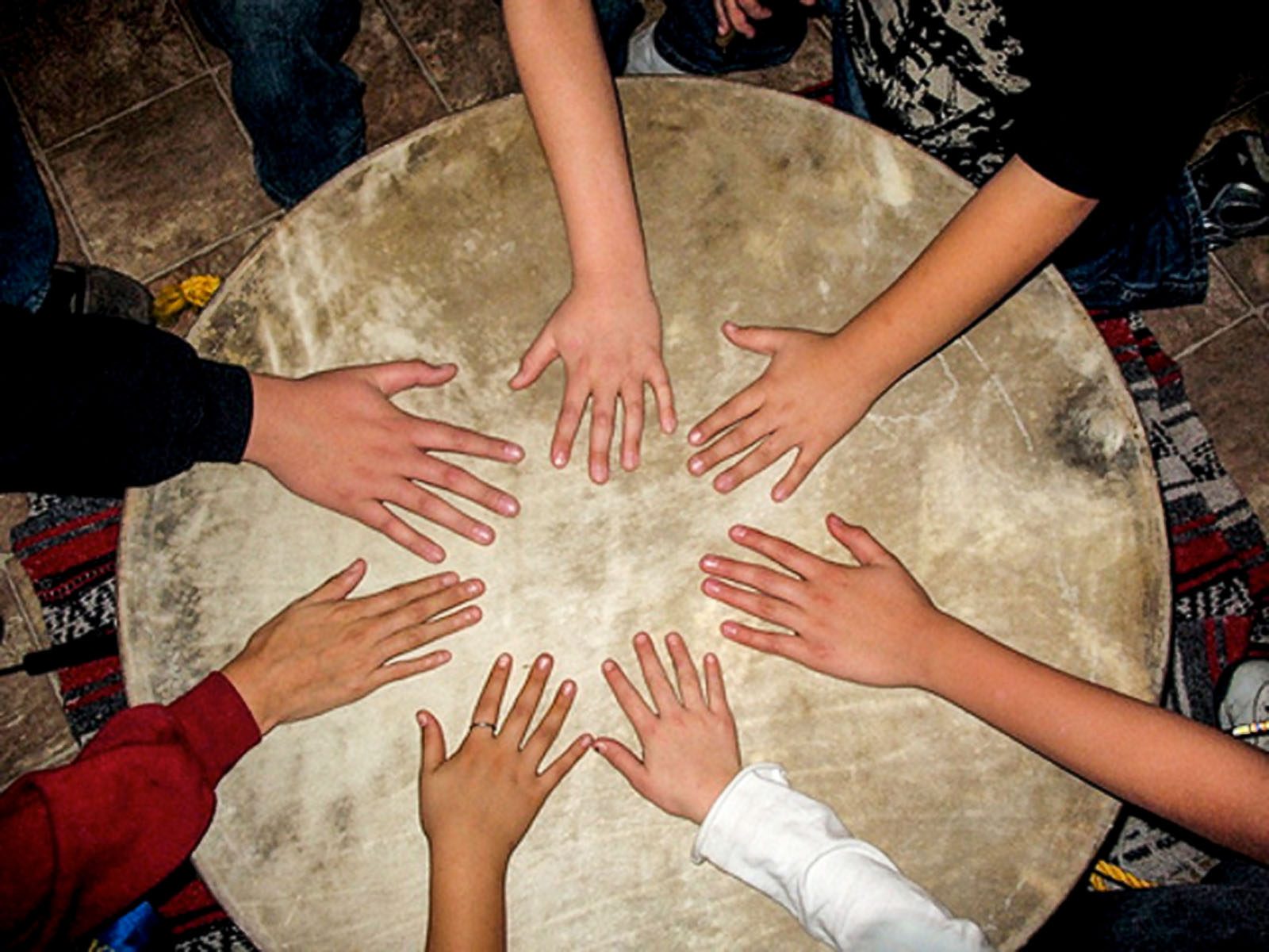 Hands in a Circle on an Indigenous Drum