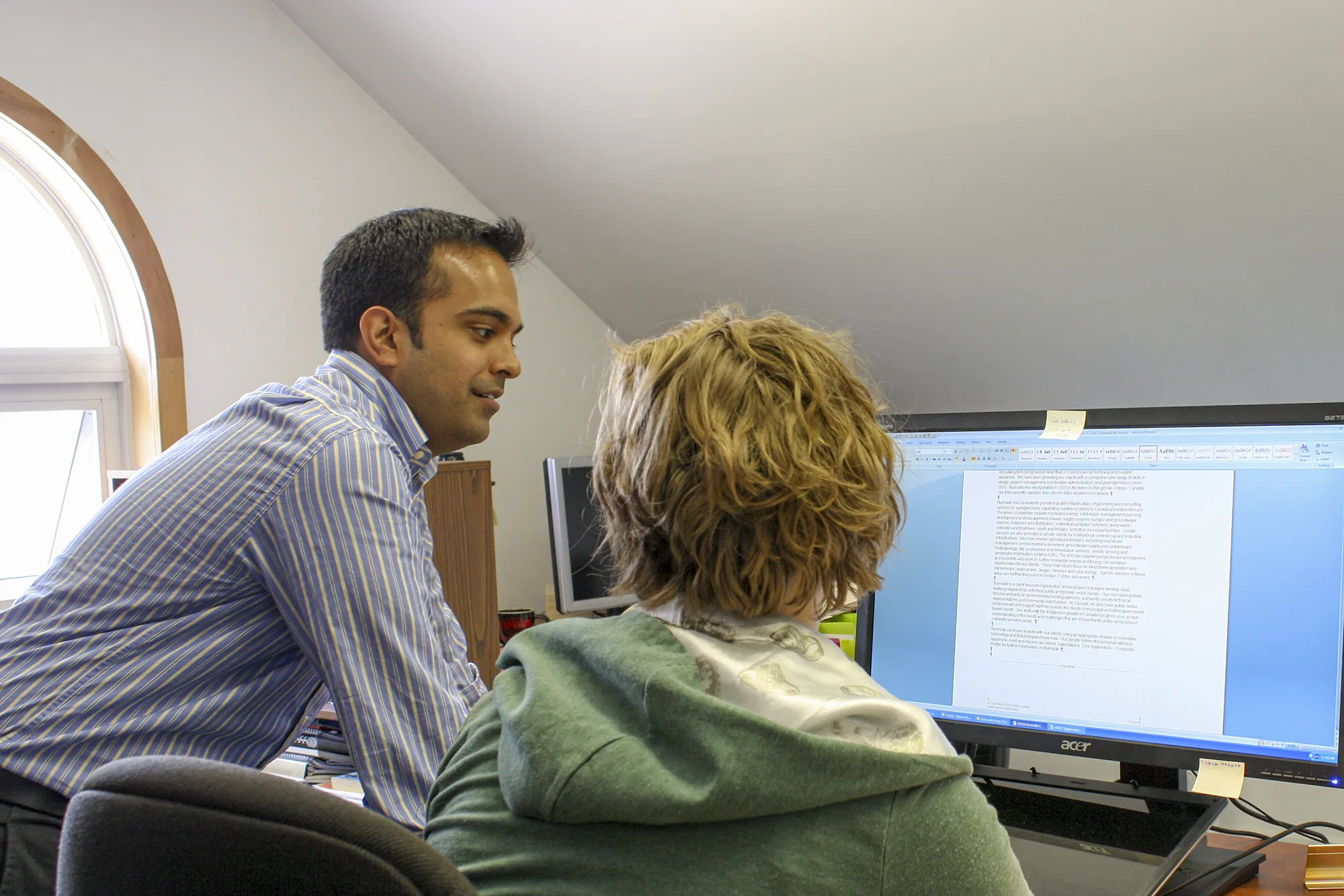Employee being mentored at computer in office